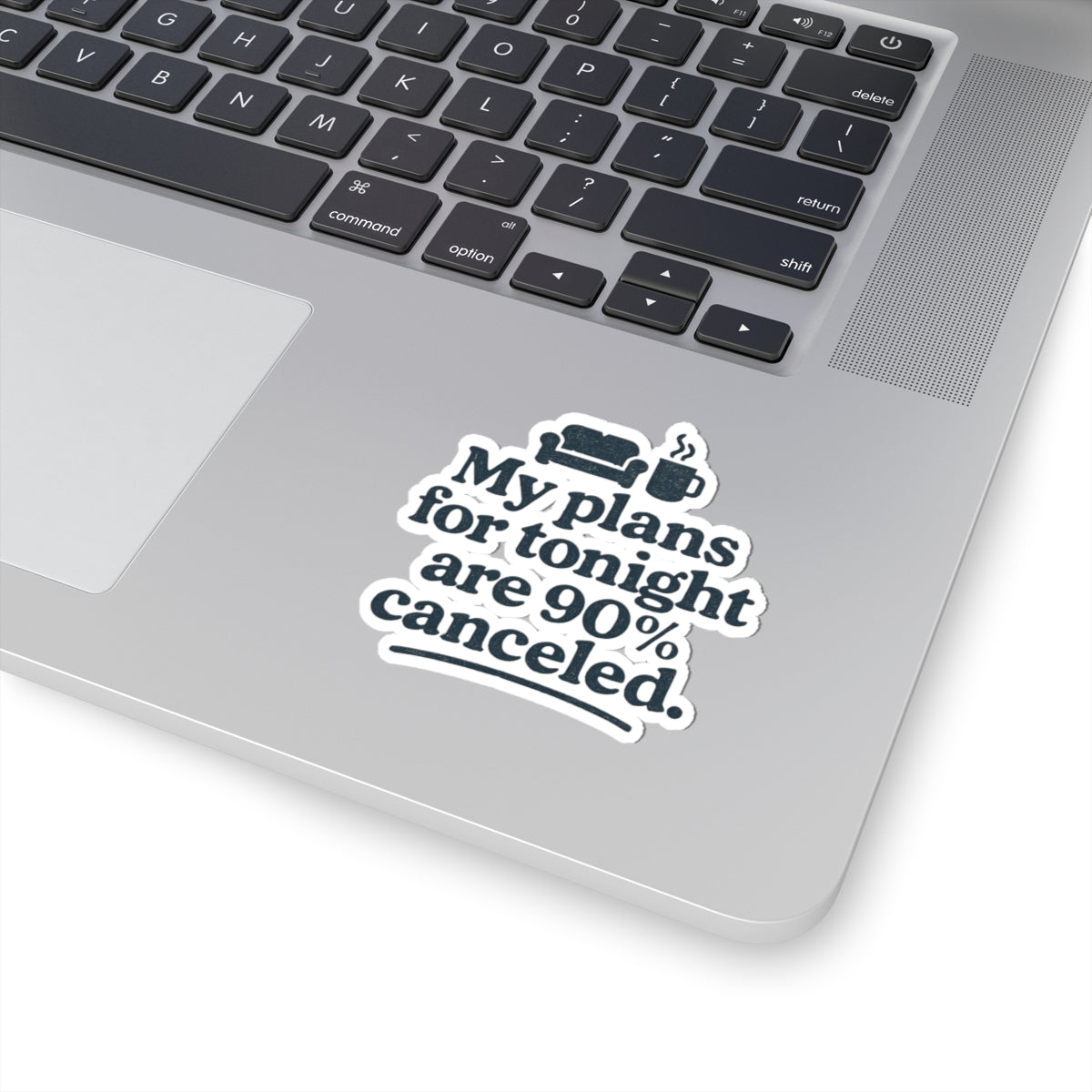 Laptop with a sticker reading 'My plans for tonight are 90% canceled' on a white background