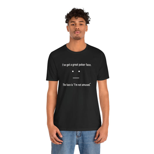 Person wearing a black t-shirt with text 'I've got a great poker face. The face is I'm not amused.' and a face graphic on a white background