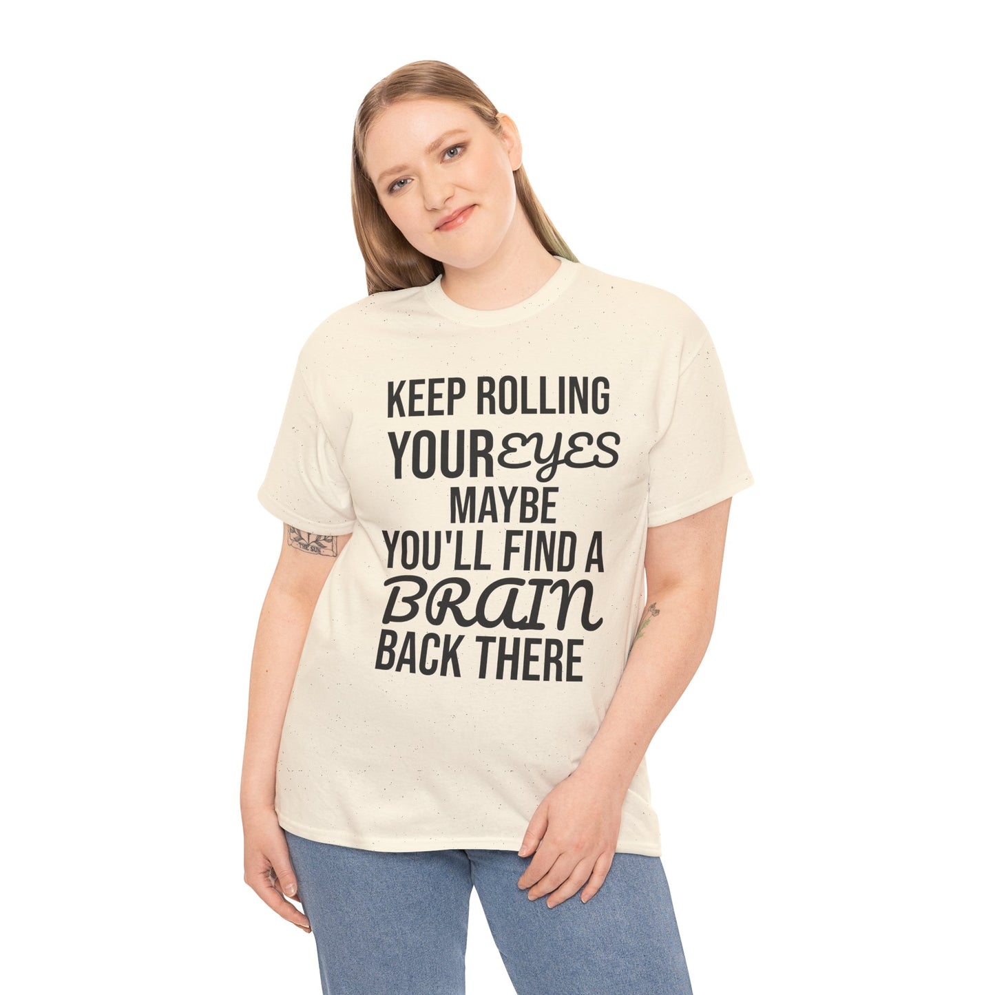 Person wearing a cream t-shirt with humorous text 'KEEP ROLLING YOUR EYES MAYBE YOU'LL FIND A BRAIN BACK THERE' design on a white background