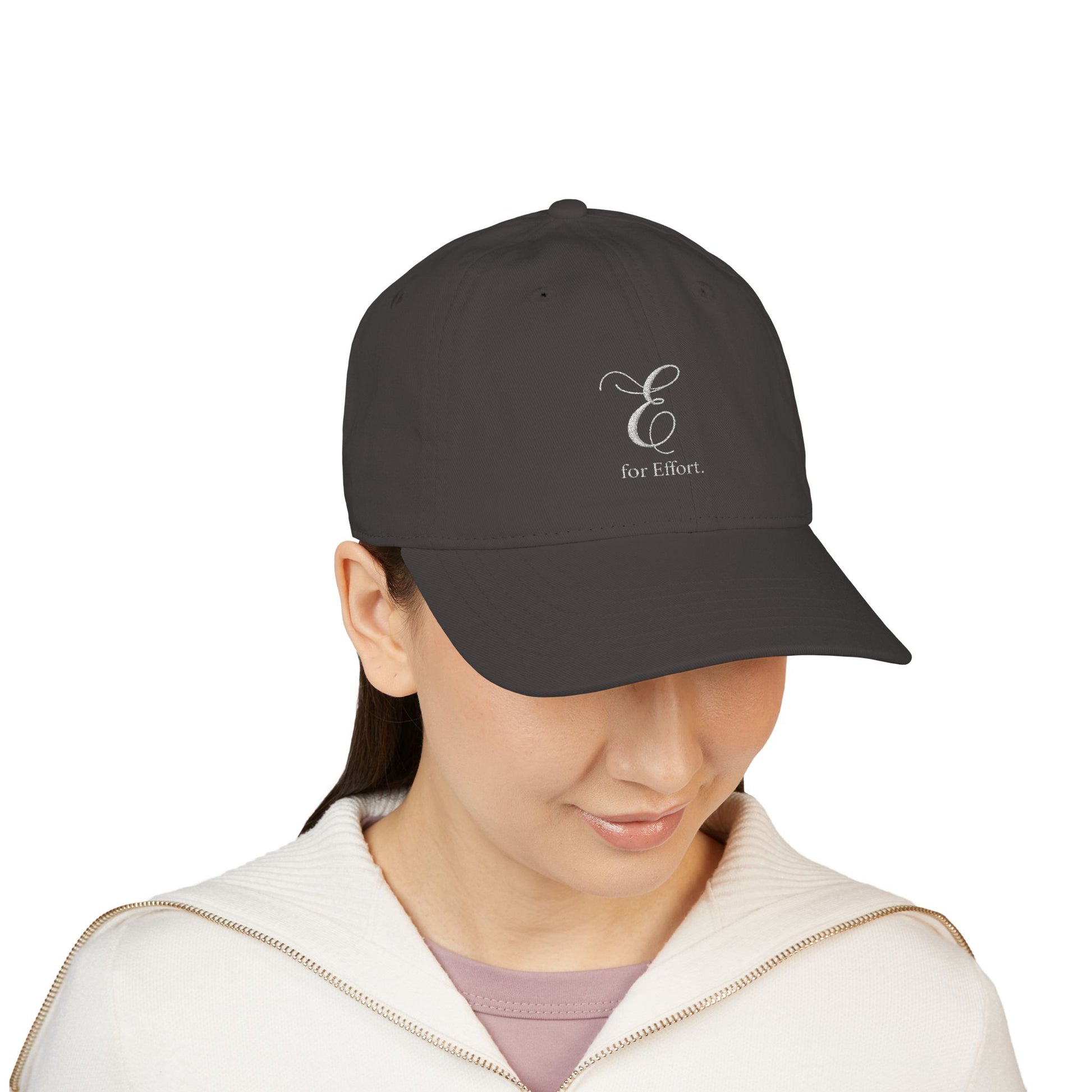 Person wearing a black cap with an embroidered logo and text 'E for Effort' on a white background