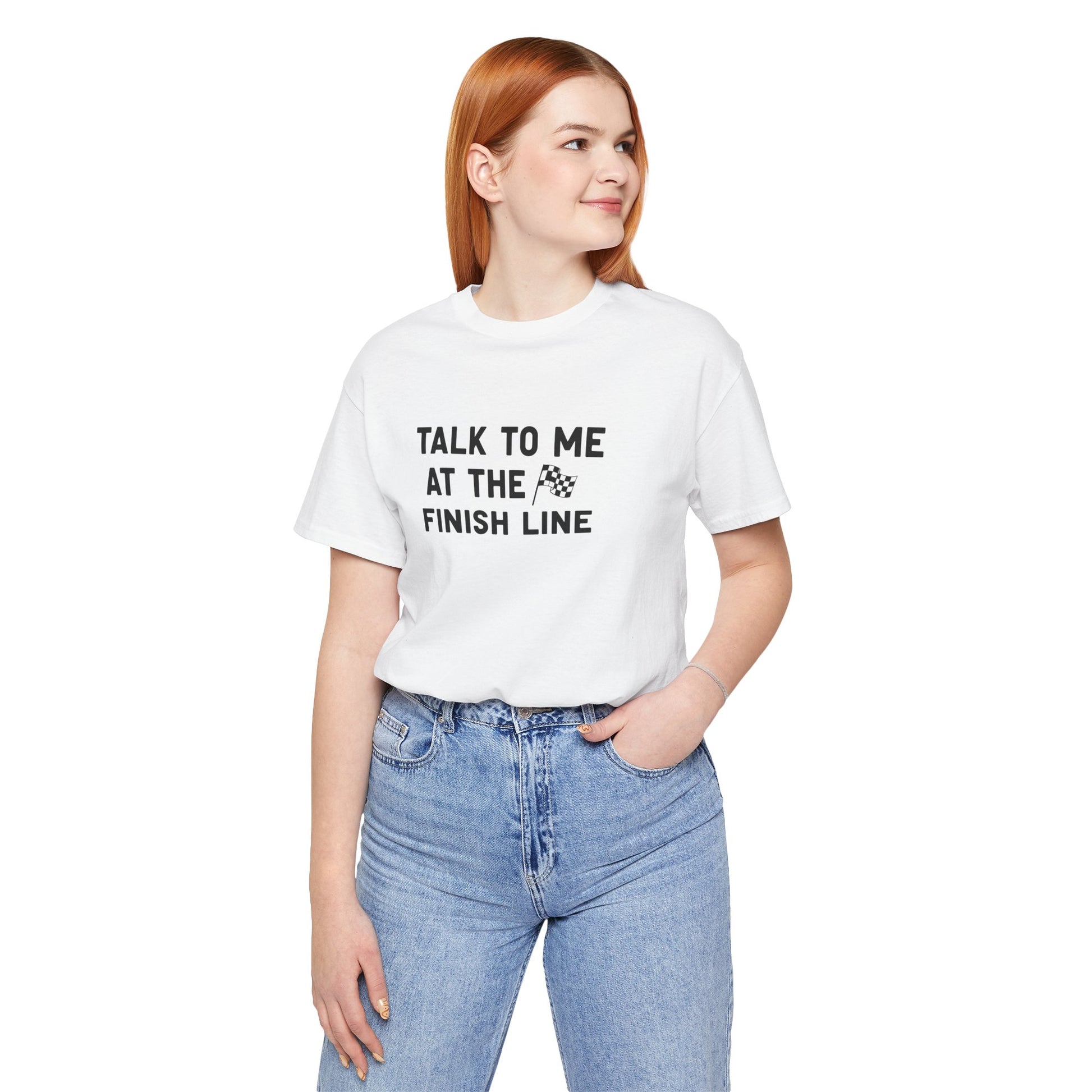 Person wearing a white t-shirt with text 'Talk to me at the finish line' on a white background