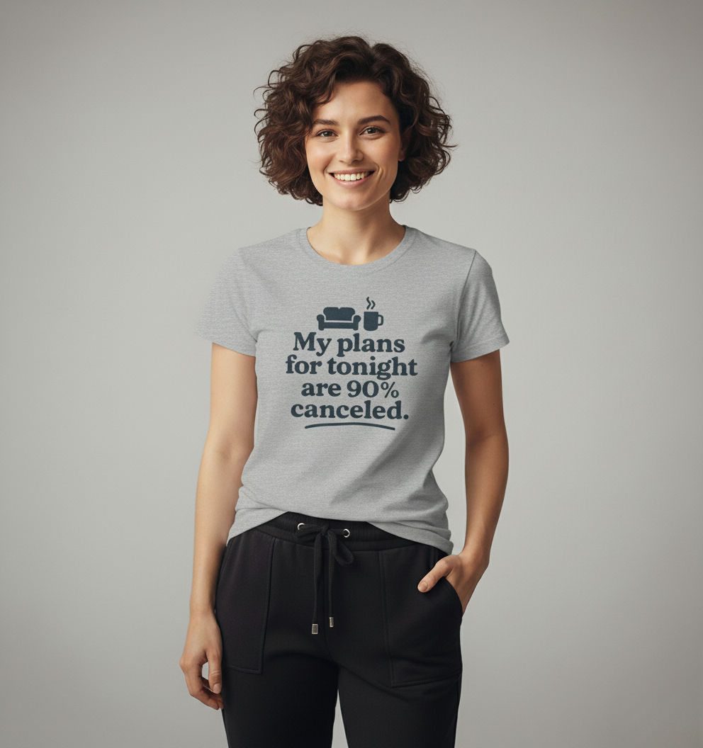 Woman wearing a gray t-shirt with text 'My plans for tonight are 90% canceled' on a plain background