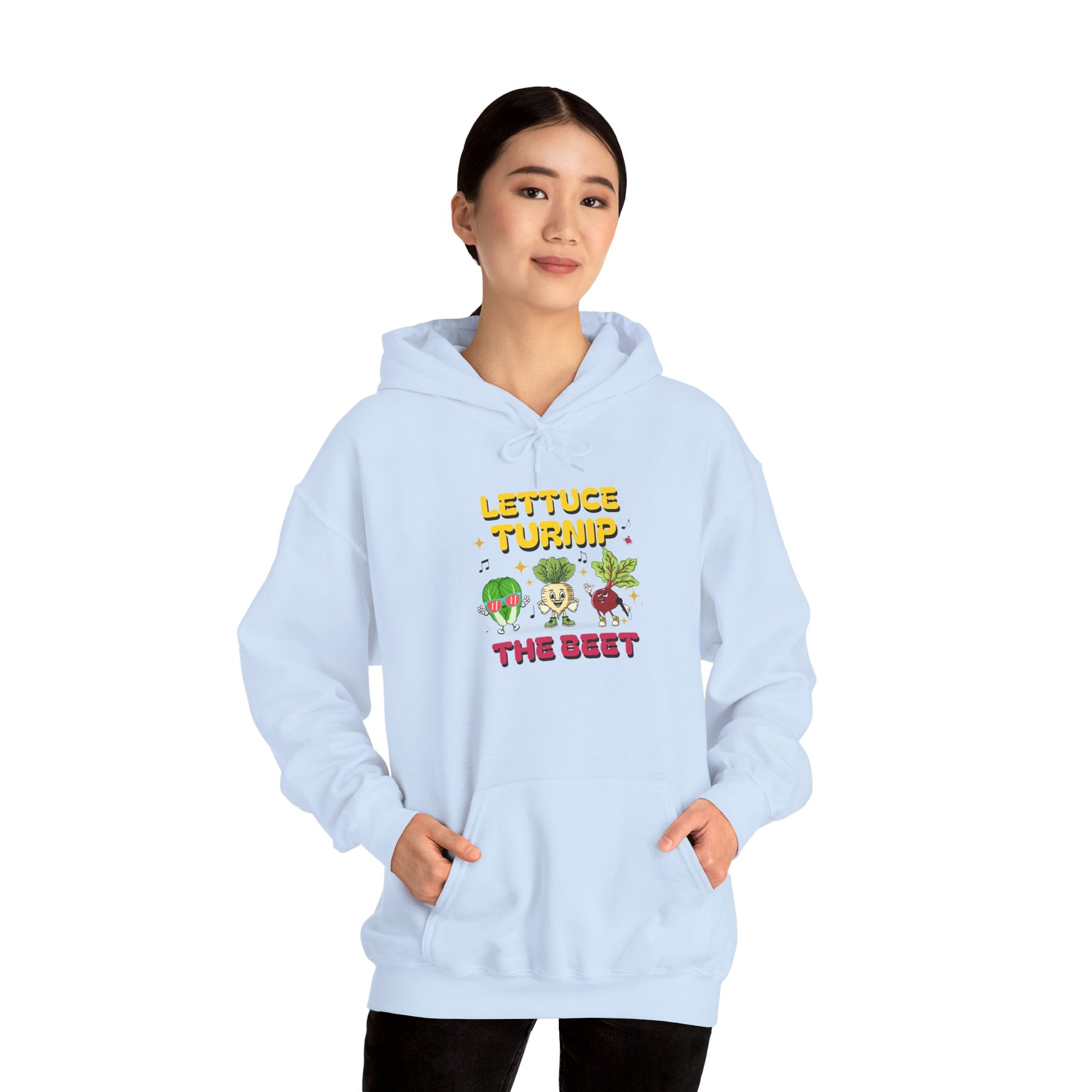Person wearing a light blue hoodie with vegetable-themed design and text 'Lettuce Turnip the Beet' on a white background