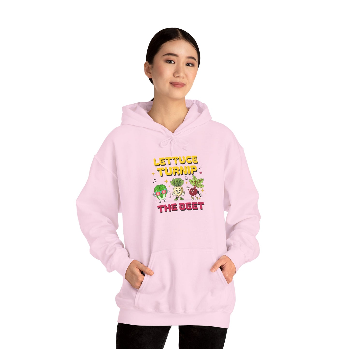 Person wearing a pink hoodie with vegetable-themed text 'Lettuce Turnip the Beet' on a white background