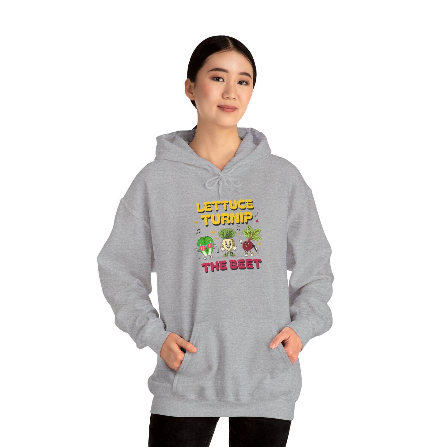 Person wearing a gray hoodie with vegetable-themed text 'Lettuce Turnip the Beet' and graphics on a white background