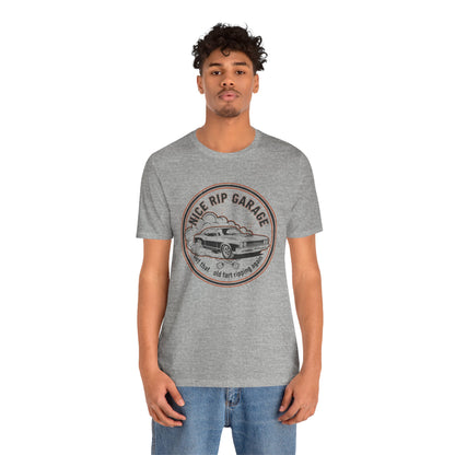 Person wearing a gray t-shirt with a graphic design and text 'Nice Rip Garage Get that old fart ripping again' on a white background