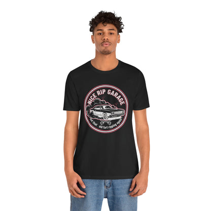 Person wearing a black t-shirt with a graphic design and text 'Nice Rip Garage Get that old fart ripping again' on a white background