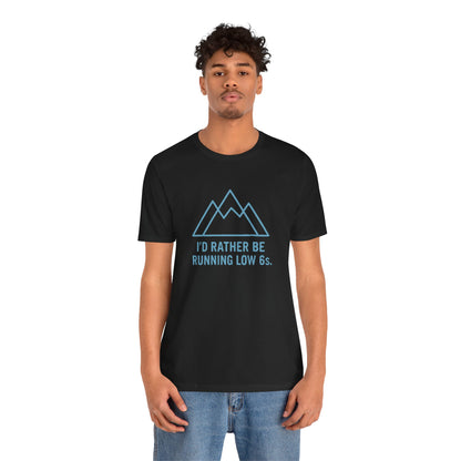 Person wearing a black t-shirt with a mountain graphic and text 'I'd rather be running low 6s' on a white background