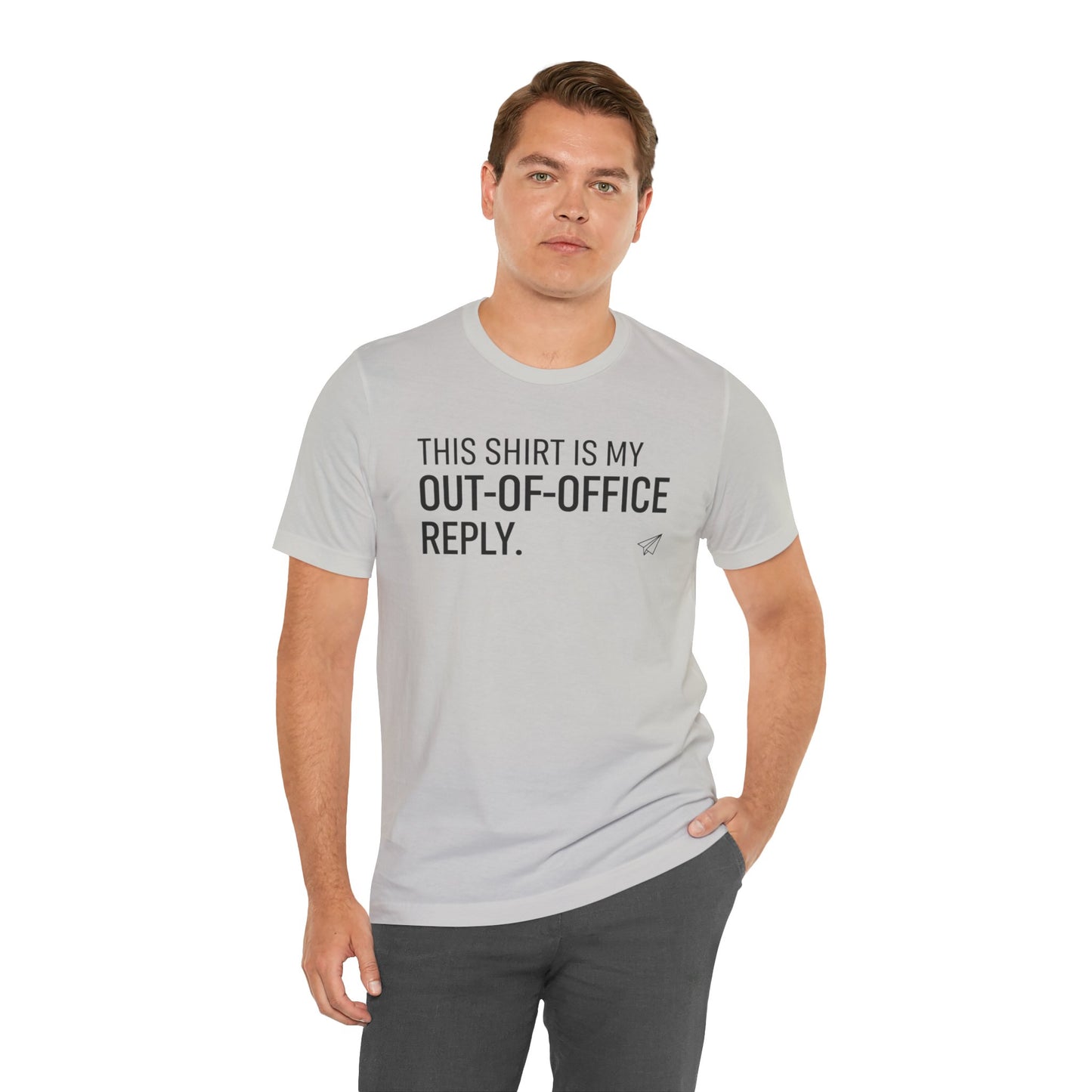 Man wearing a gray t-shirt with humorous text 'This shirt is my out-of-office reply' on a white background