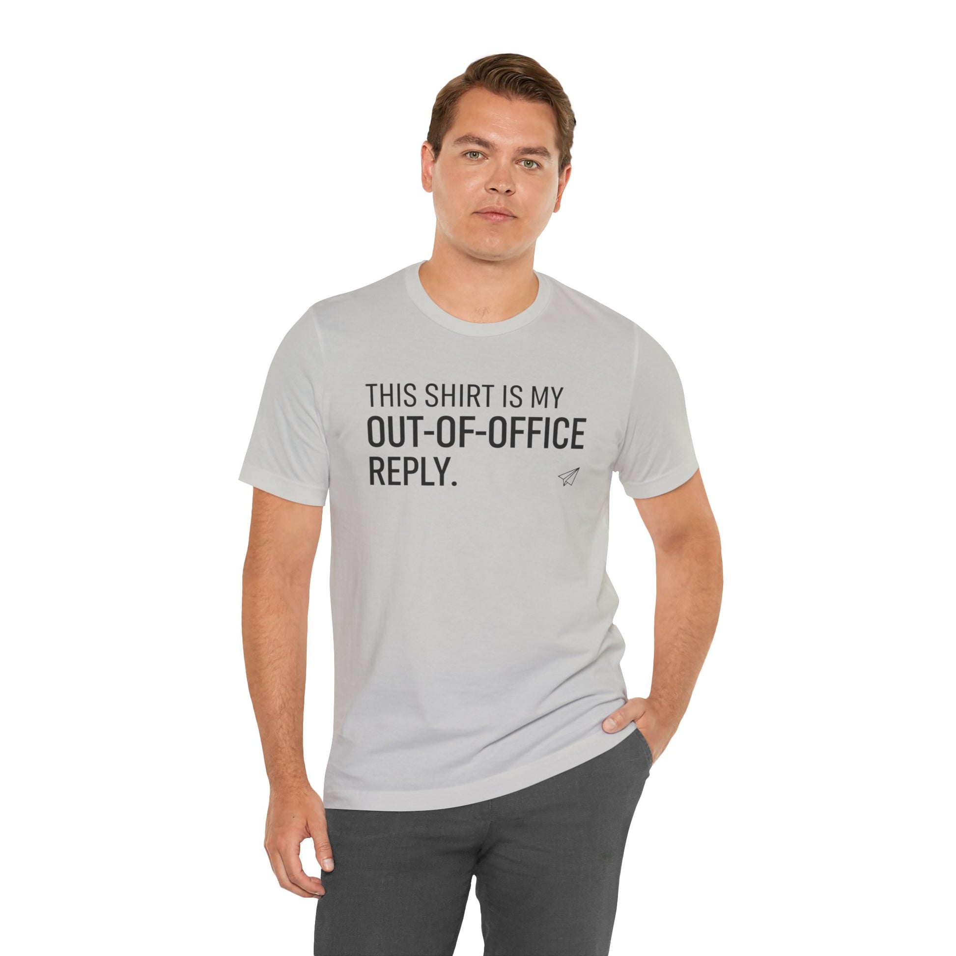 Man wearing a gray t-shirt with humorous text 'This shirt is my out-of-office reply' on a white background