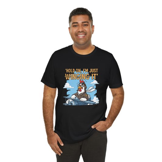 Man wearing a black t-shirt with a cartoon character and text on a white background
