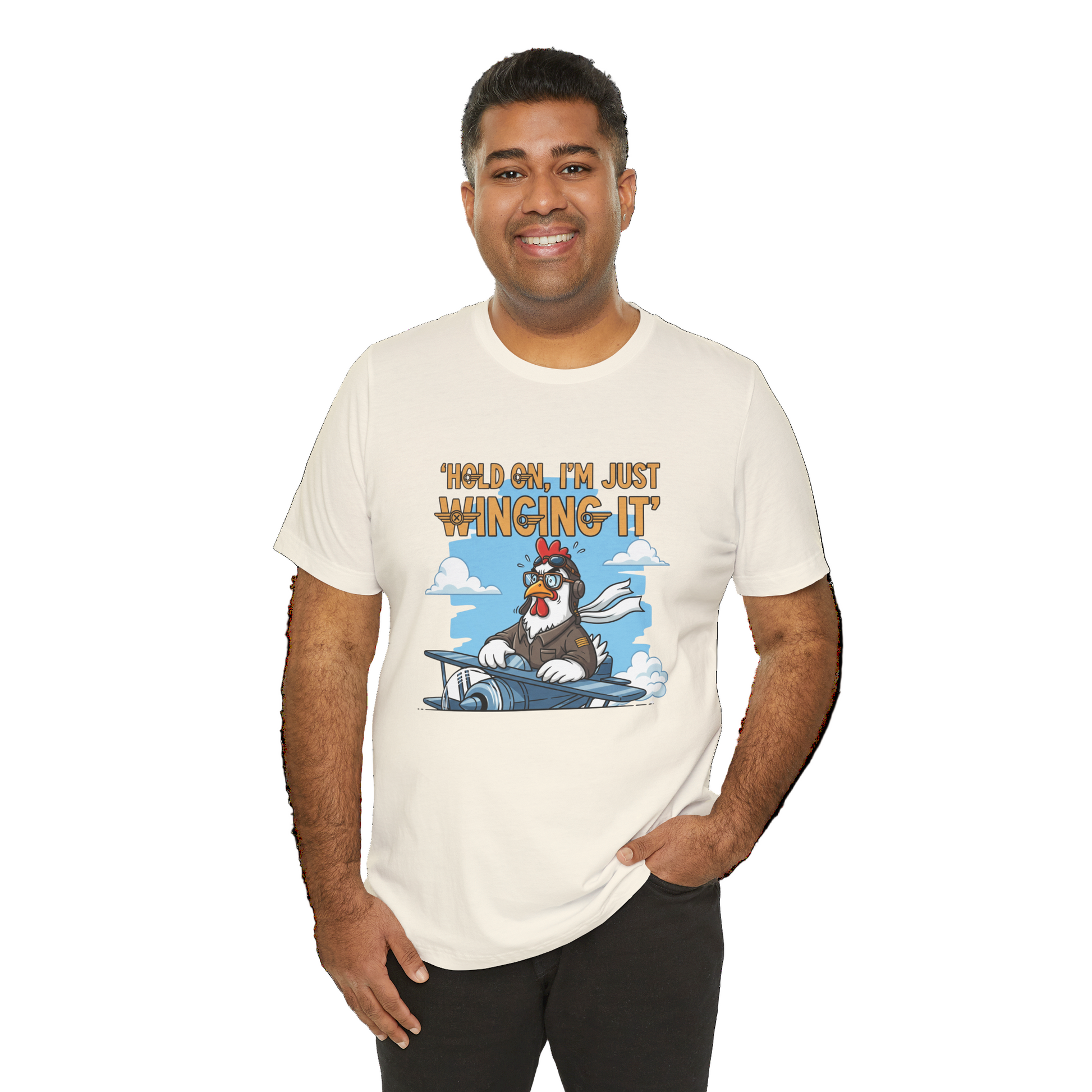Man wearing a t-shirt with a cartoon character and text 'Hold on, I'm just winging it' on a white background