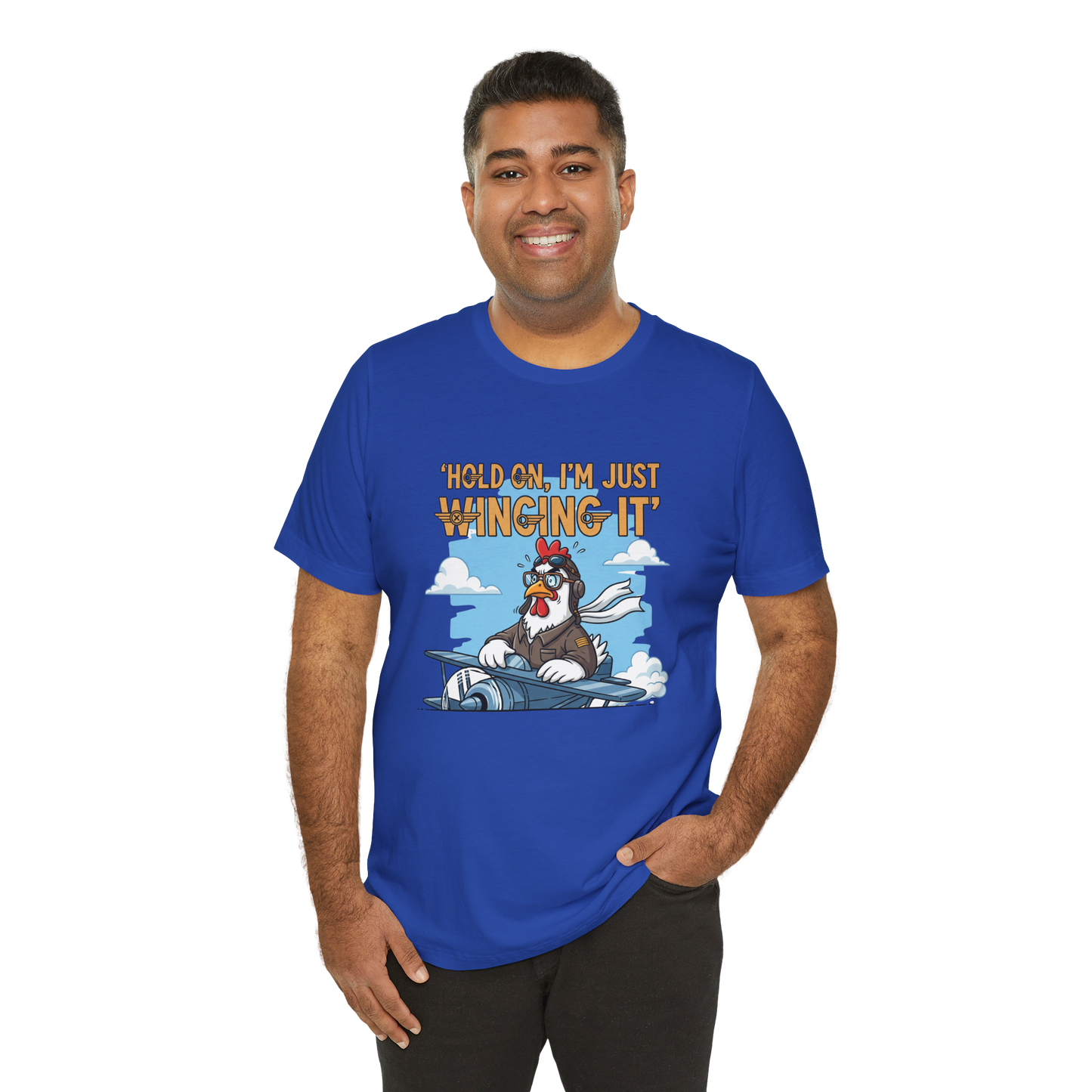 Man wearing a blue t-shirt with a cartoon character and text 'Hold on, I'm just winging it' on a white background