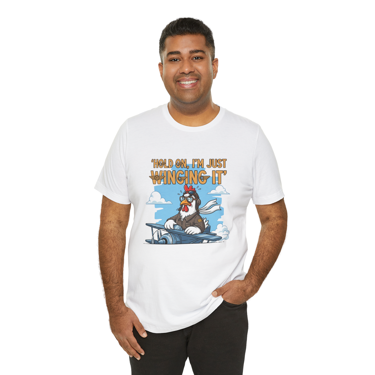 Man wearing a white t-shirt with a cartoon character and text 'Hold on, I'm just winging it' on a white background