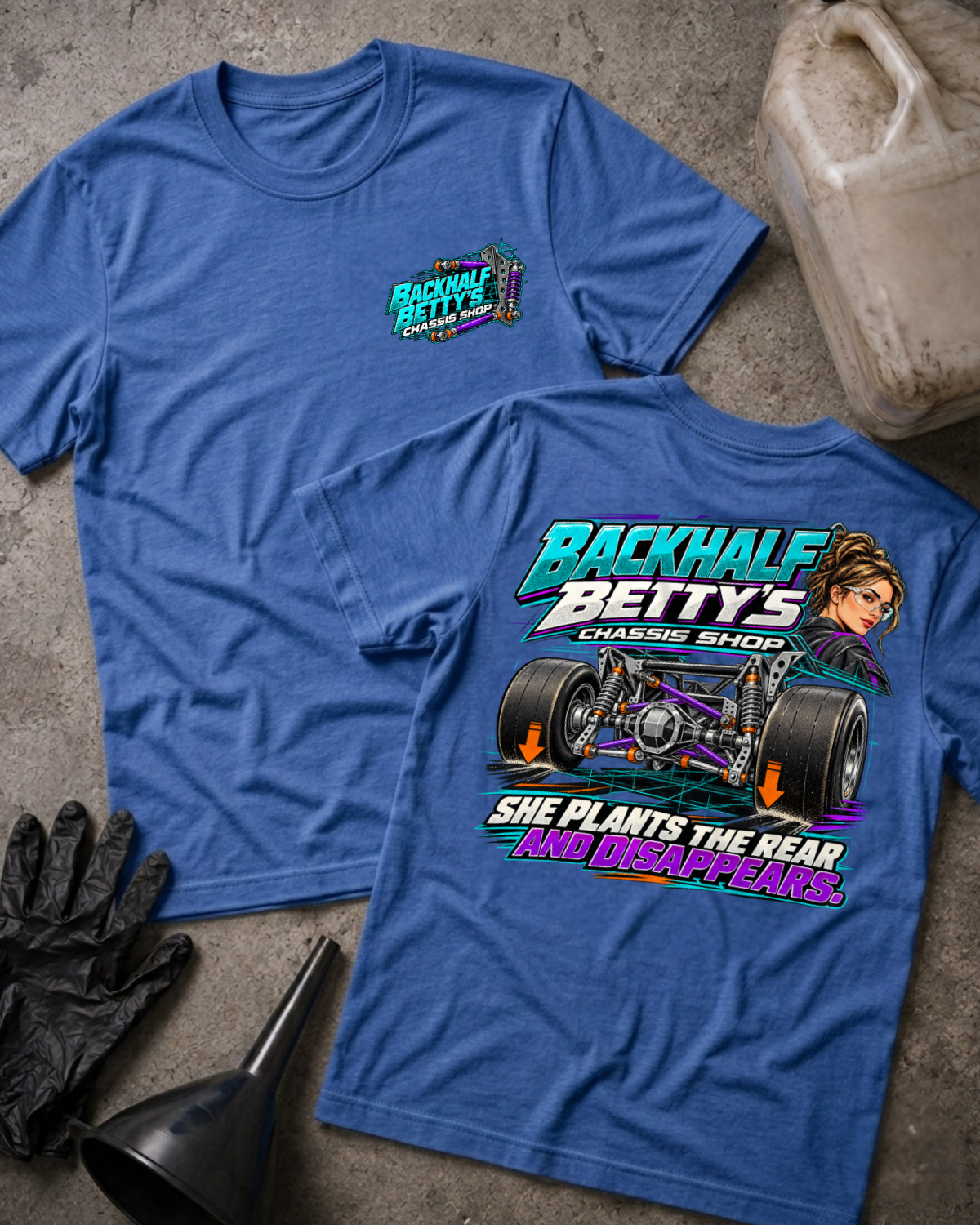 Heather True Royal Backhalf Betty’s T-shirt, front and back views, with chest logo and teal-and-purple drag chassis graphic reading “She plants the rear and disappears.”