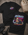 Two black graphic T-shirts laid flat on a textured gray surface, with a vintage gas can, black gloves, and a black funnel as styled props. The front shirt shows a small multicolor 'Big Booty Judy' chest graphic, and the back shirt shows a large colorful graphic of a woman standing on a pink car with the text 'Big Booty Judy' and 'Always Rides For Free'.