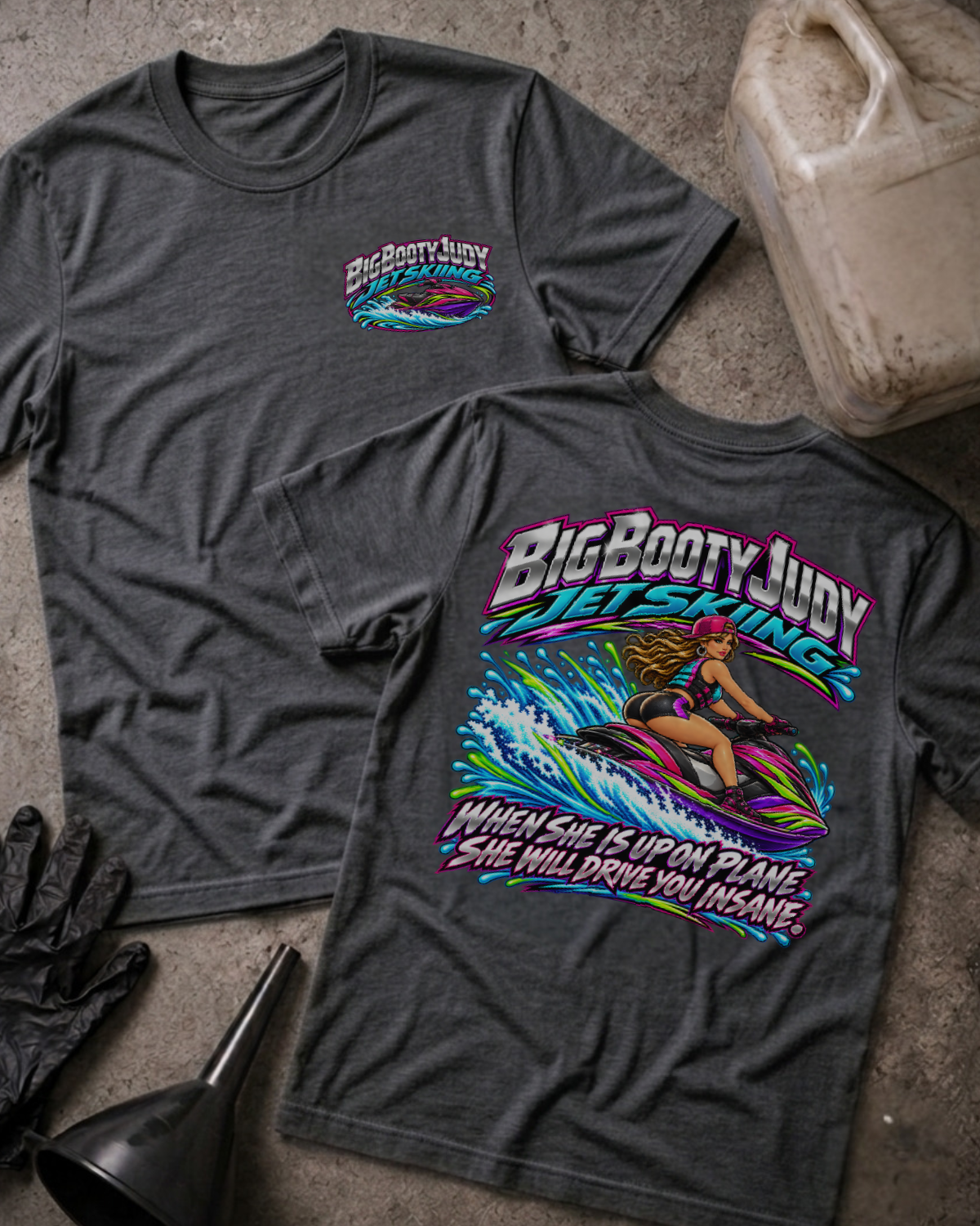 Dark Grey Heather Big Booty Judy Jet Skiing T-shirt, front and back views with a chest logo and colorful woman riding a jet ski above the slogan “When she is up on plane she will drive you insane.”