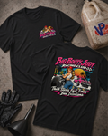 Two black graphic T-shirts laid flat on a textured gray surface, with racing-themed artwork and text. One shirt shows a small chest graphic, and the other shows a large back graphic with the words 'Big Booty Judy Racing Club' and 'Thick Slicks, Fast Time, and Bad Decisions'.