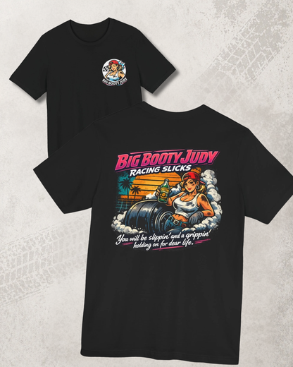 Black t-shirt with 'Big Booty Judy Racing Slicks' graphic design on a textured gray background