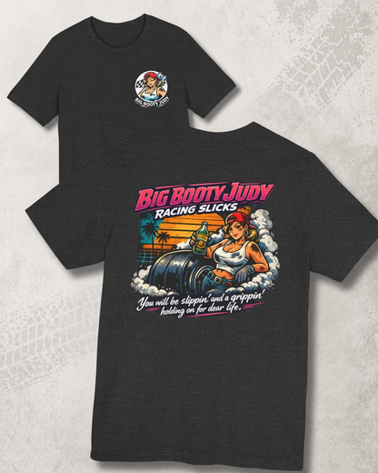 Black t-shirt with 'Big Booty Judy Racing Slicks' graphic design on a textured white background