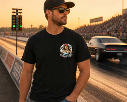 Man wearing a black t-shirt with a Big Booty Judy logo graphic design on a race track at sunset
