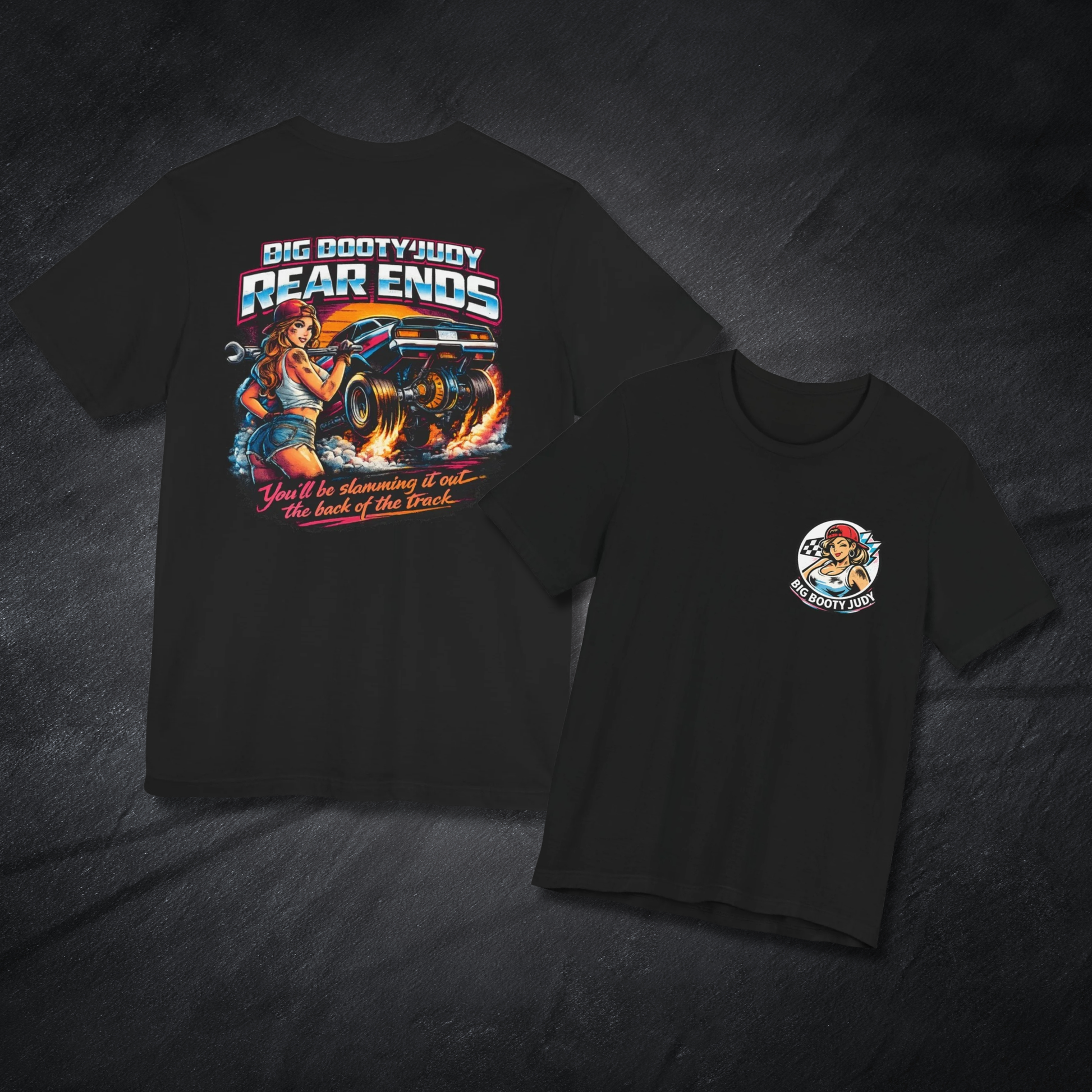 Black t-shirt with Big Booty Judy Rear Ends graphic design on front and back on a dark textured background