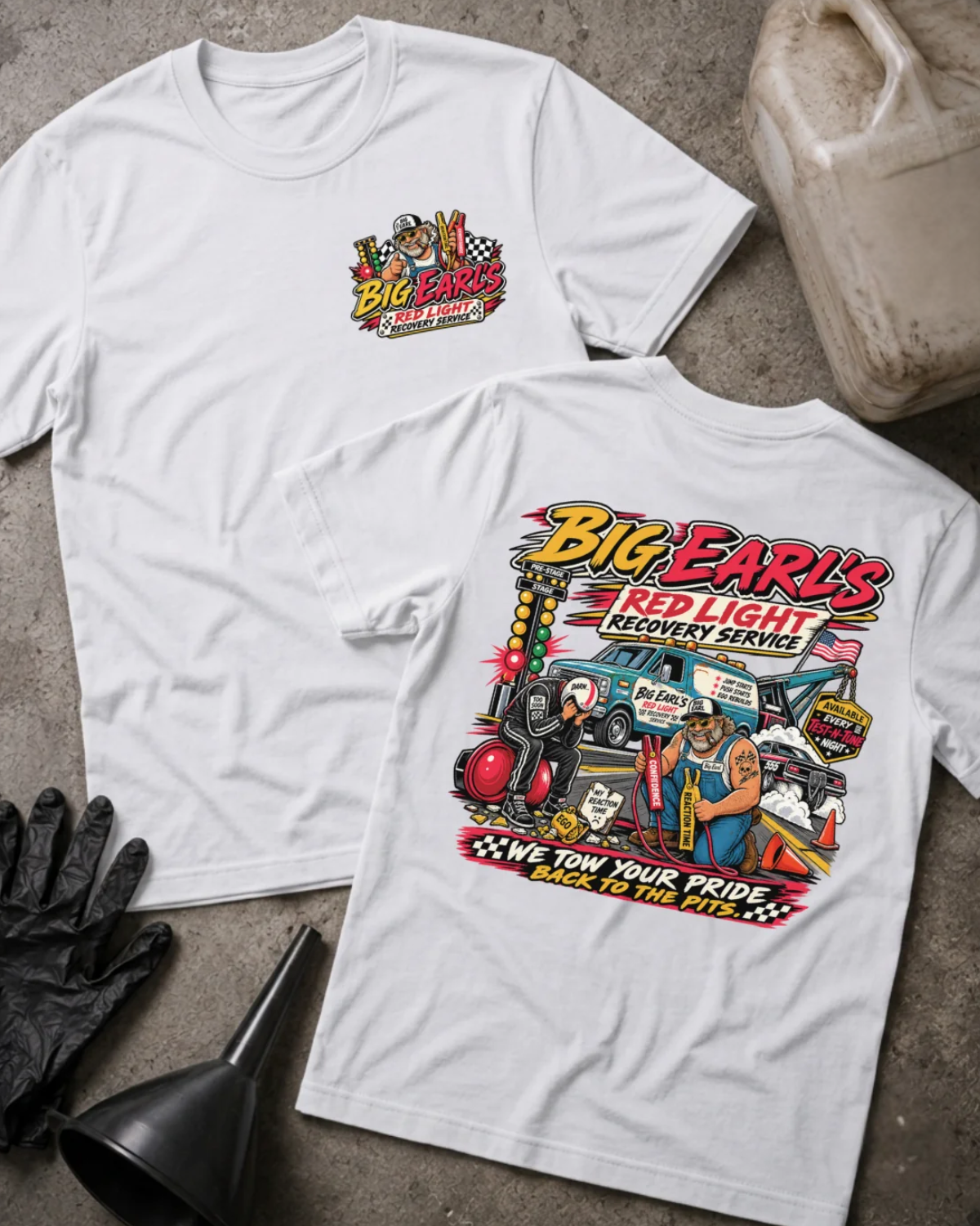 Front and back of Big Earl’s Red Light Recovery white T-shirt with chest logo, tow truck, mechanic and helmeted racer beside a red starting light, and “We tow your pride back to the pits” slogan.