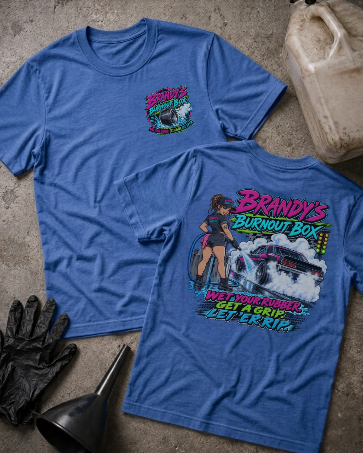 Front and back of Brandy’s Burnout Box heather true royal T-shirt with chest logo, woman beside a smoking drag car, and “Wet Your Rubber” slogan.
