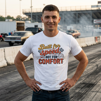 Man wearing a white t-shirt with 'Built for Speed, Not for Comfort' text at a race track.
