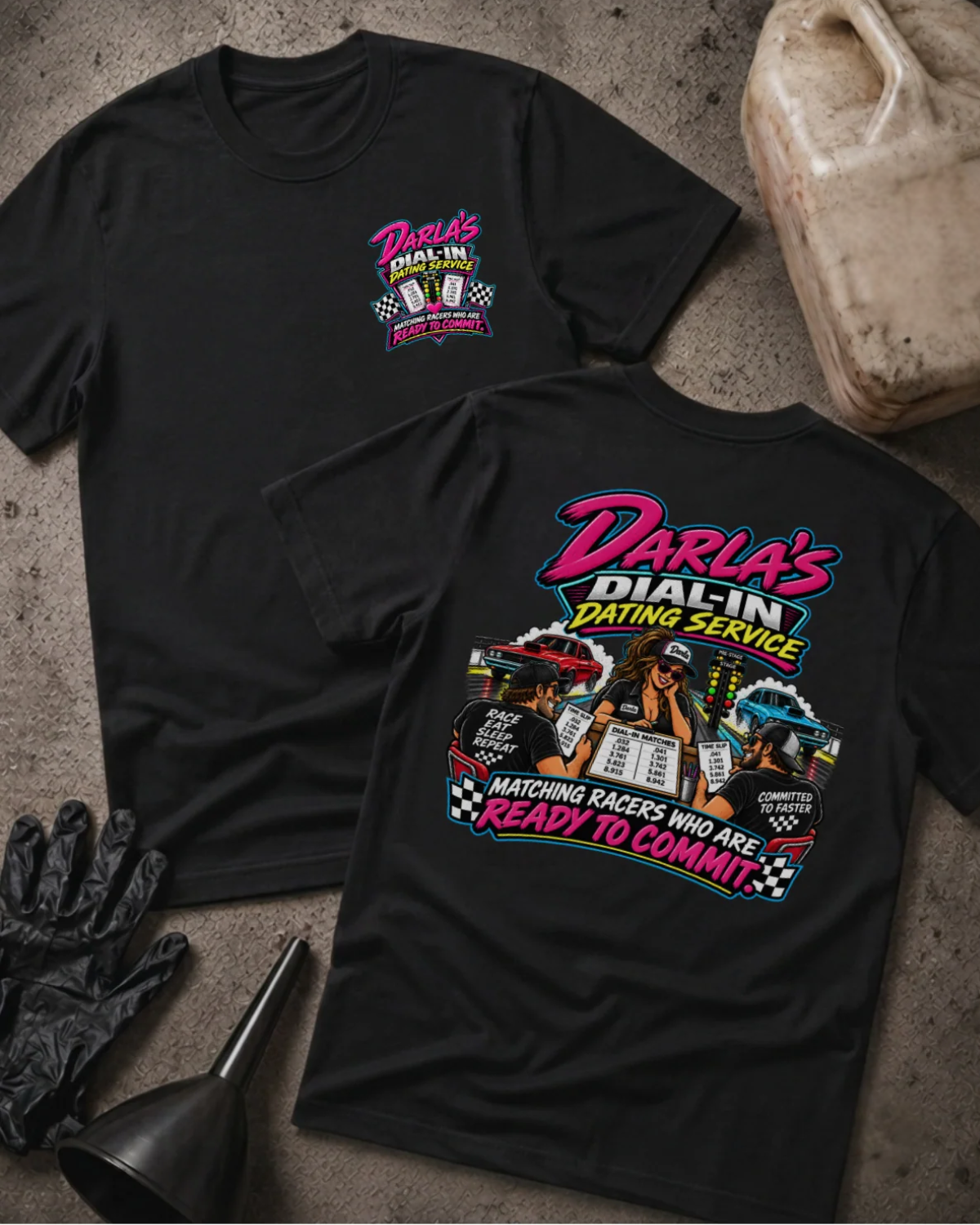 Front and back of Darla’s Dial-In Dating Service black T-shirt with chest logo, woman matching two racers, drag cars, and “Matching racers who are ready to commit” slogan.