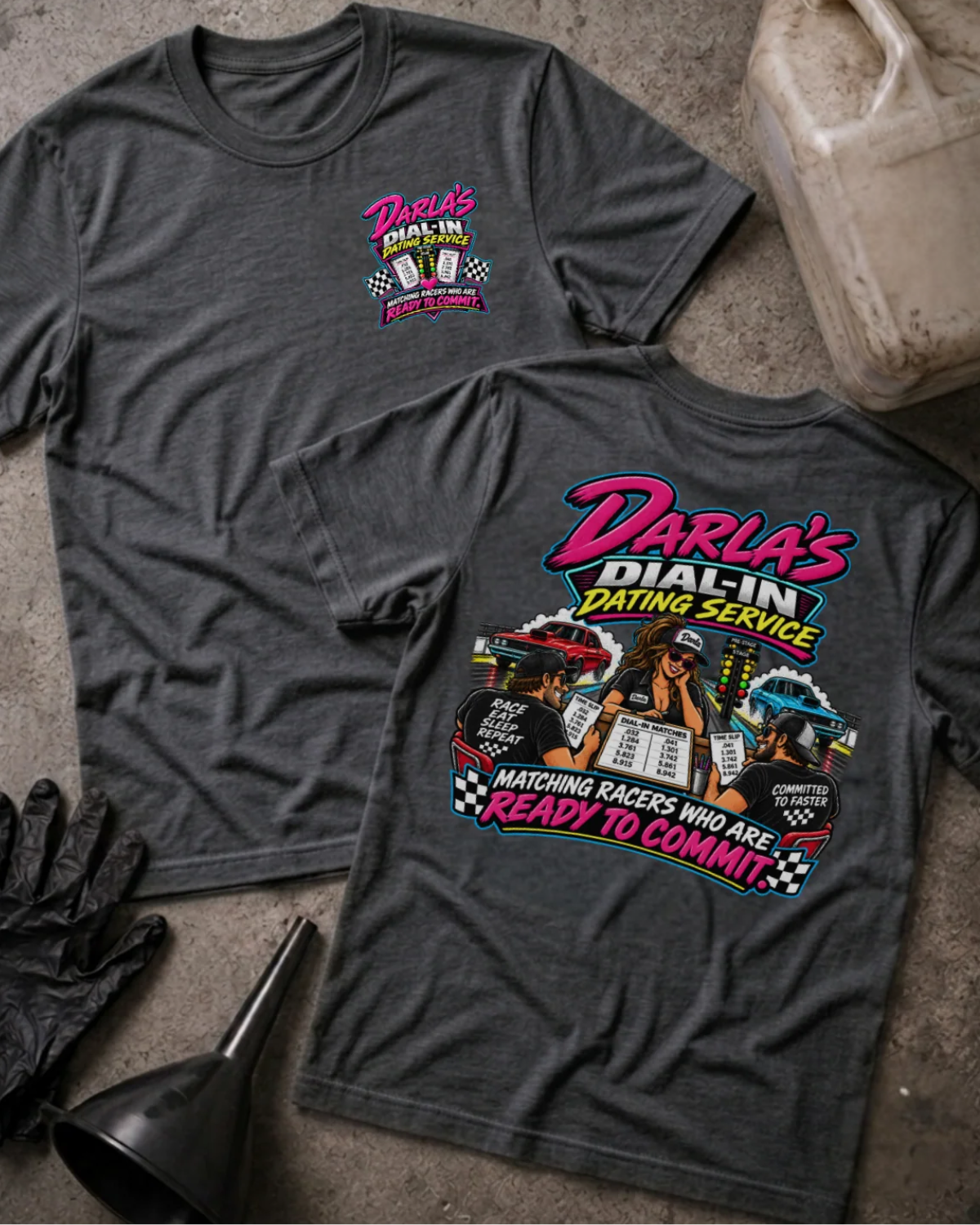 Front and back of Darla’s Dial-In Dating Service dark grey heather T-shirt with chest logo, woman matching two racers, drag cars, and “Matching racers who are ready to commit” slogan.