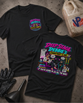 Two black graphic T-shirts laid flat on a textured concrete-like surface, showing the front and back designs. The shirts feature colorful neon-style artwork and text reading 'Deep Stage Debbie's Commitment Clinic' and 'If you're going in go all the way.