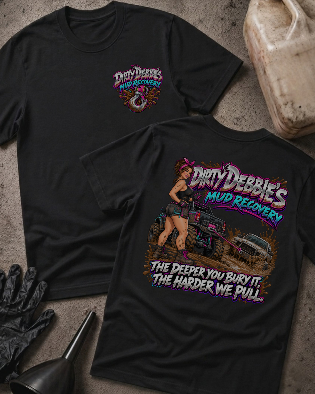 Black Dirty Debbie’s Mud Recovery T-shirt, front and back views with a chest tow-hook logo and a woman beside trucks in mud, plus “The deeper you bury it, the harder we pull.”