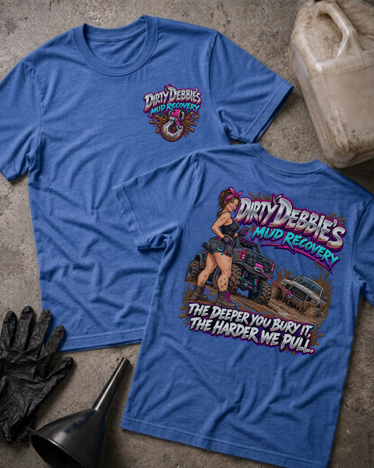 Heather true royal blue Dirty Debbie’s Mud Recovery T-shirt, front and back views with a chest tow-hook logo and a woman beside trucks in mud, plus “The deeper you bury it, the harder we pull.”