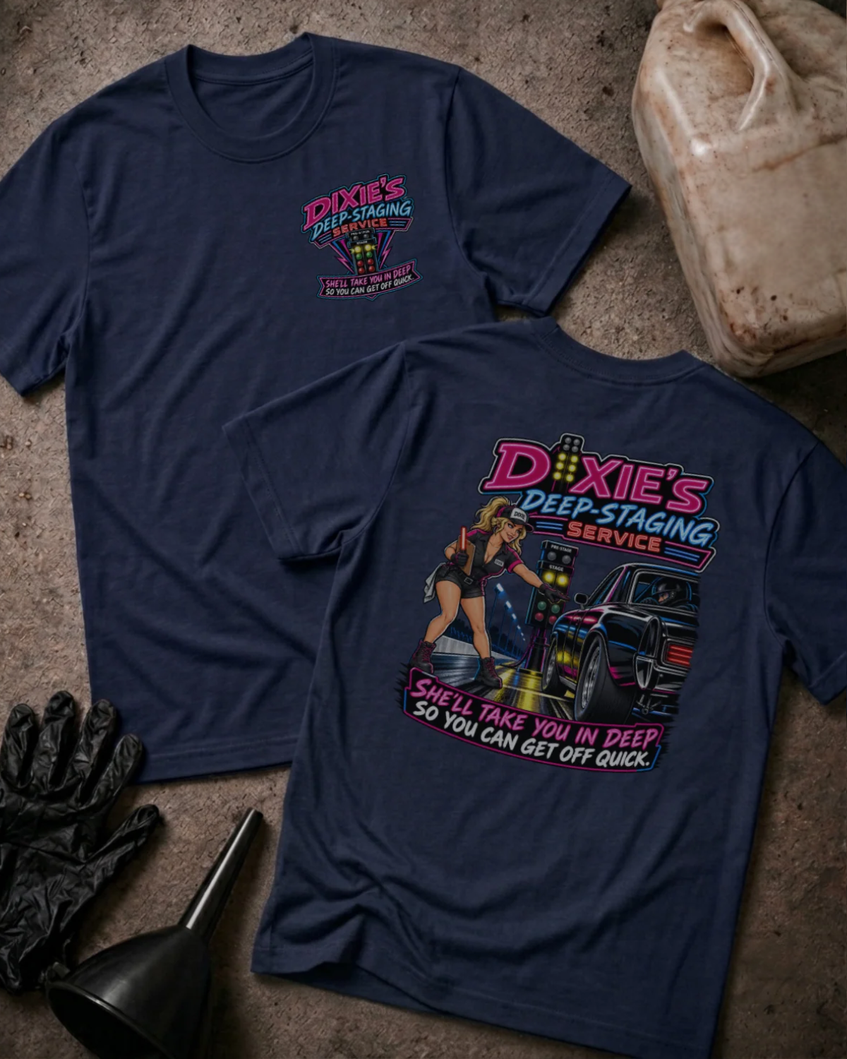 Front and back of Dixie’s Deep Staging Service navy T-shirt with chest logo, woman beside a drag car and staging lights, and “She’ll take you in deep so you can get off quick” slogan.