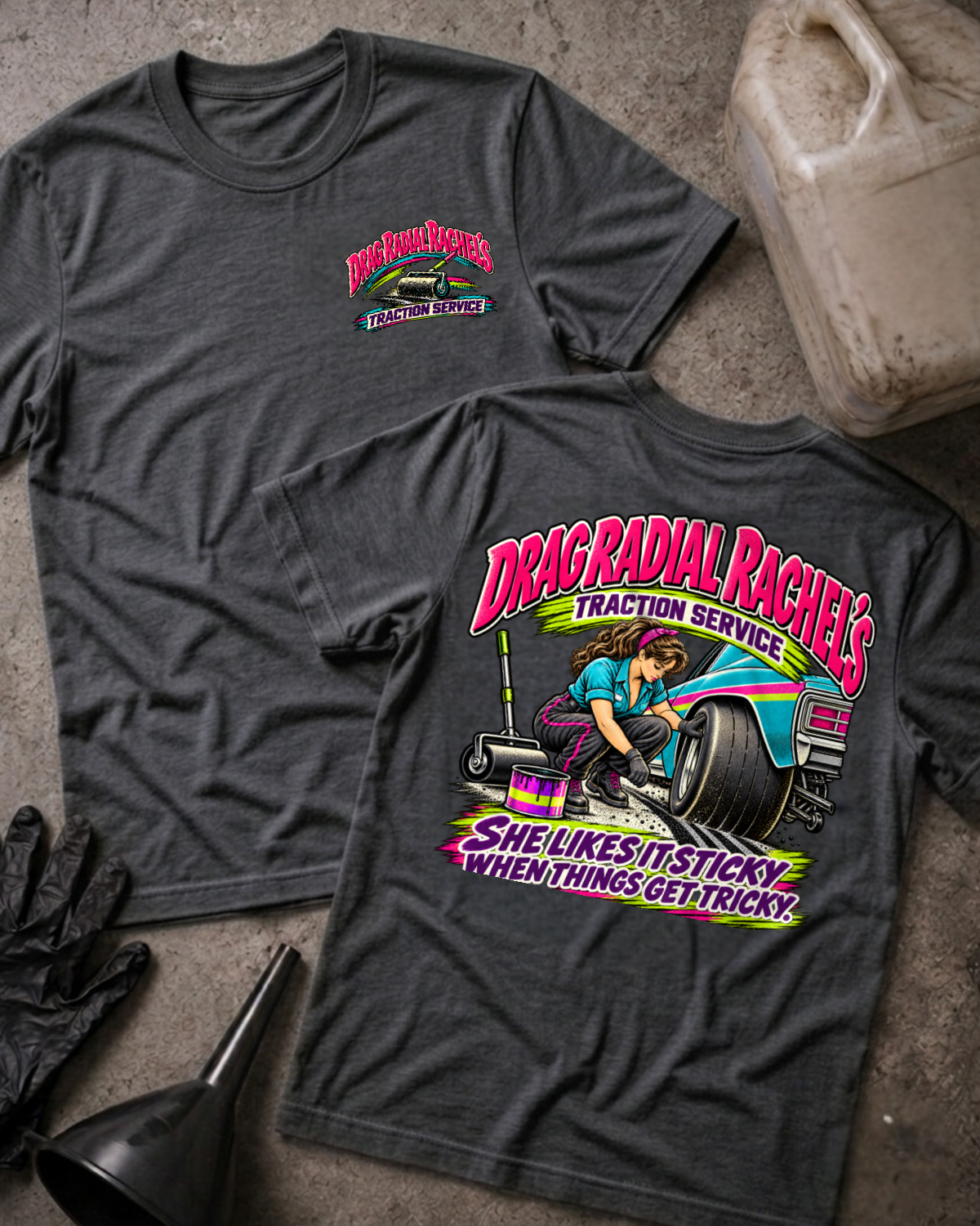 Dark Grey Heather Drag Radial Rachel’s T-shirt, front and back views, with Traction Service chest logo and colorful back graphic of a woman prepping a wide tire beside a teal race car.