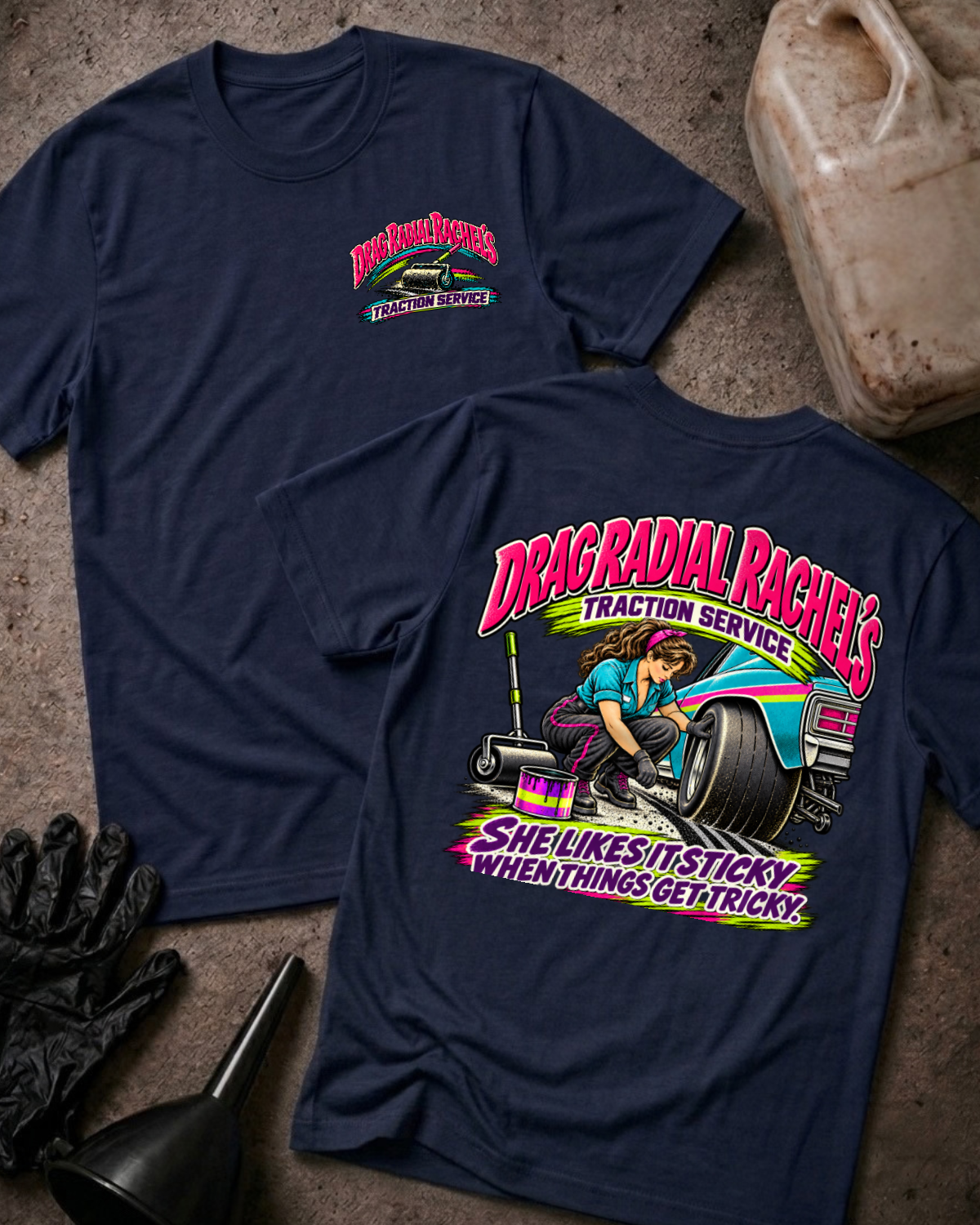 Navy Drag Radial Rachel’s Traction Service T-shirt, front and back views, with chest logo and back graphic featuring a woman, wide racing tire, teal race car, floor jack, and tire-prep can.