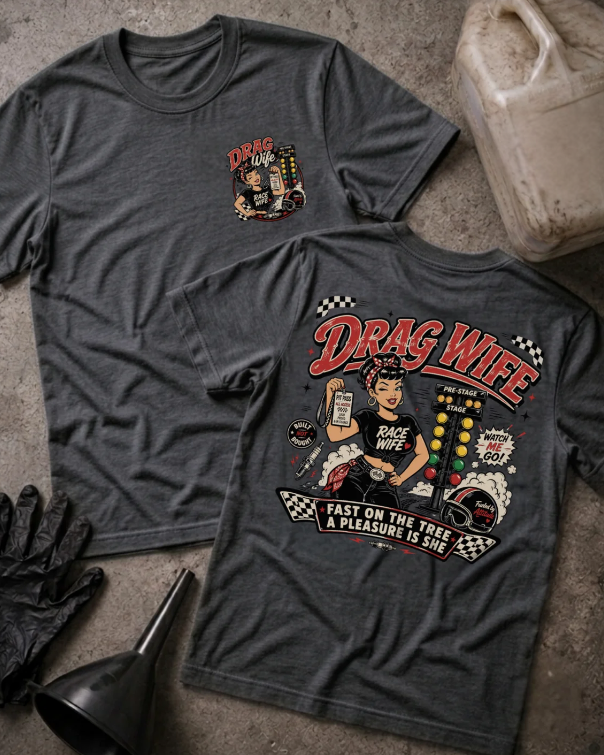Front and back of Drag Wife dark grey heather T-shirt with chest logo, woman holding a pit pass beside drag racing lights, and “Fast on the tree, a pleasure is she” slogan.