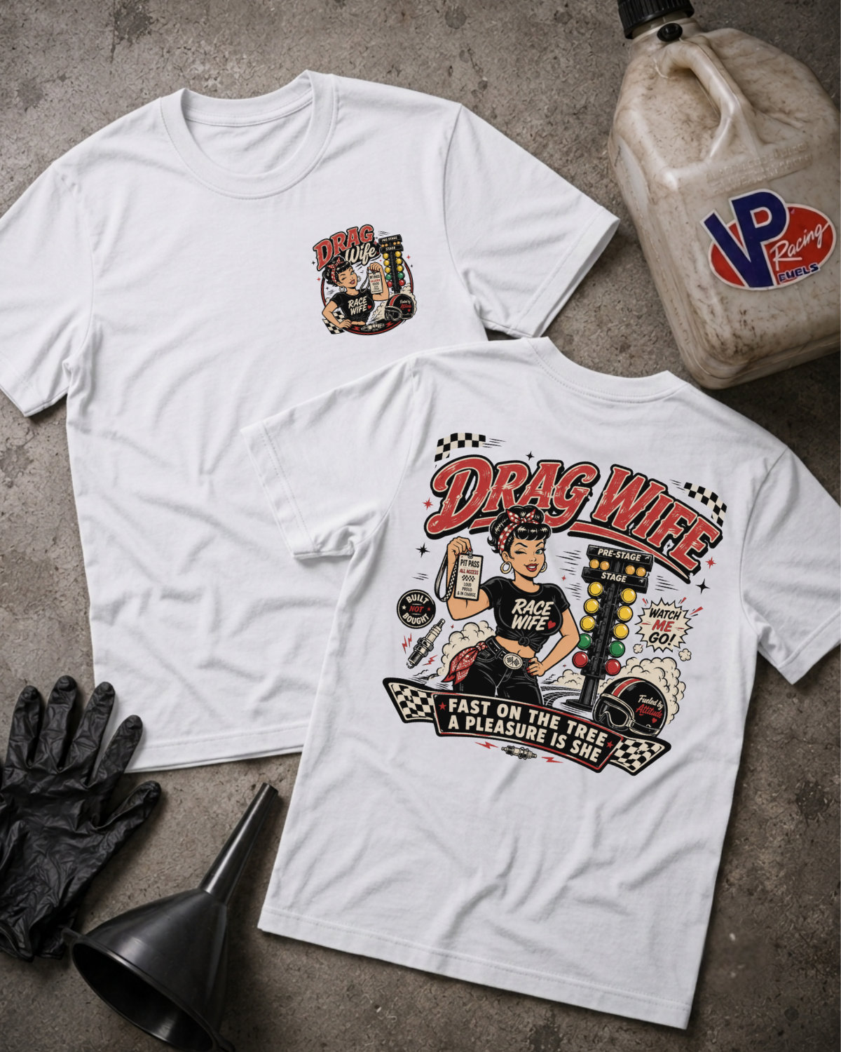 Two white graphic T-shirts laid flat on a gray concrete-style surface, showing the front and back designs. The front has a small circular 'DRAG WIFE' chest graphic, and the back has a large colorful illustration with the text 'DRAG WIFE'  and 'FAST ON THE TREE A PLEASURE IS SHE'.