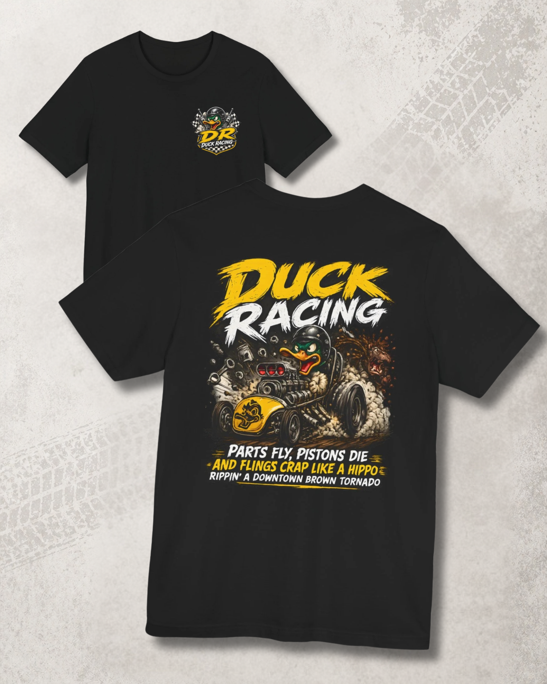 Black t-shirt with duck racing graphic and 'Parts Fly, Pistons Die, And Flings Crap Like A Hippo Rippin A Downtown Brown Tornado' text on a textured gray background