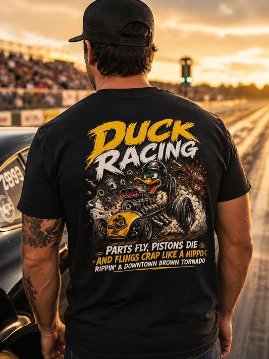 Man wearing a black t-shirt with 'Duck Racing' graphic and text at a race track.