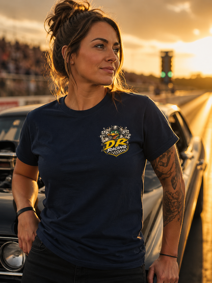Woman wearing a navy blue t-shirt with a 'Duck Racing' logo, standing in front of cars at sunset.