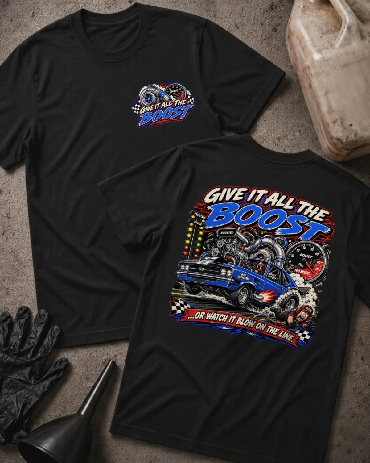 Front and back of Give It All the Boost black drag racing T-shirt with chest logo, blue turbocharged race car, boost gauge, staging lights, and “Or watch it blow on the line” slogan.