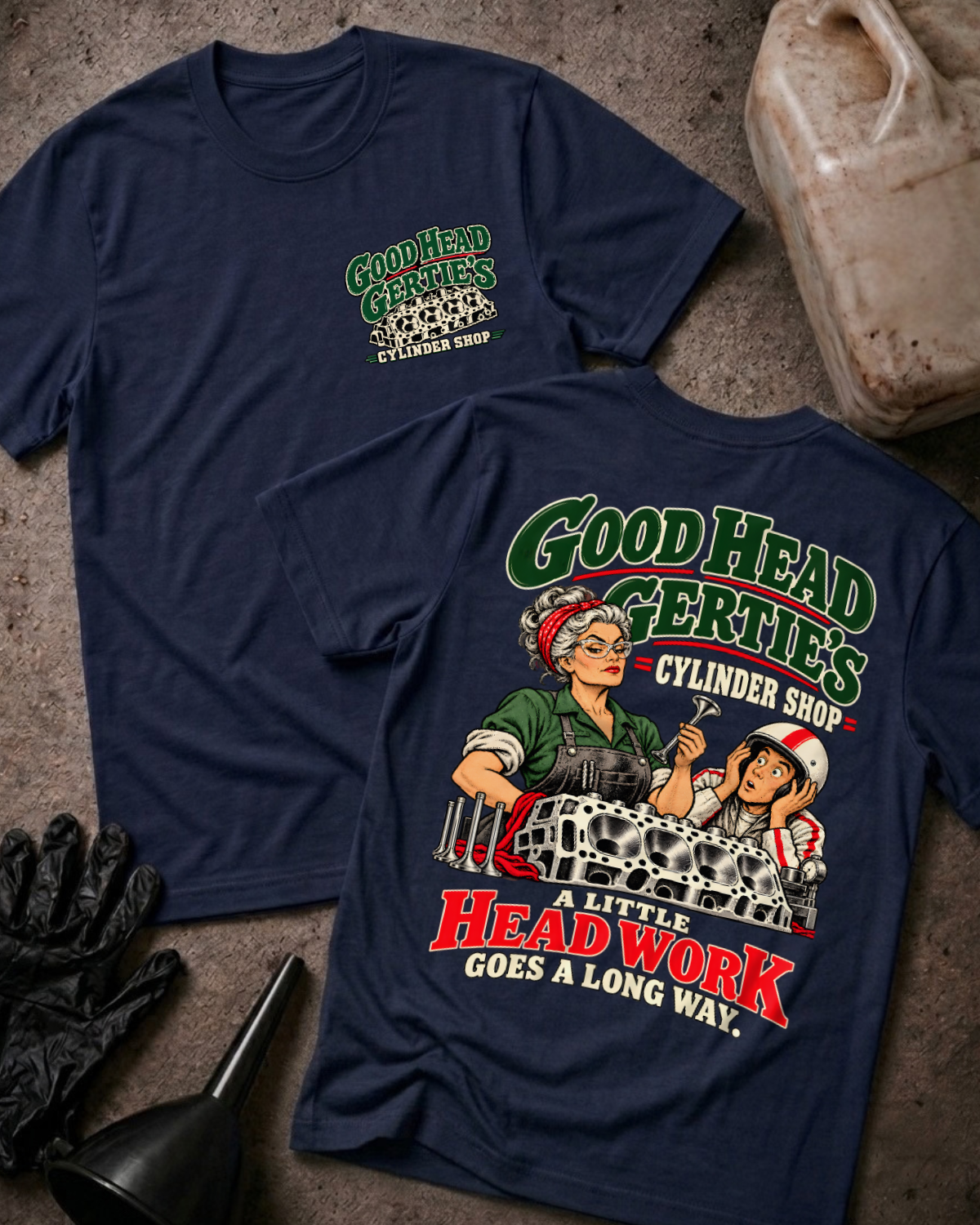 Navy Good Head Gertie’s Cylinder Shop T-shirt showing the front chest logo and back cartoon of a woman machinist machining a cylinder head beside a racer in a helmet, “A Little Head Work Goes a Long Way,” with gloves, funnel, and oil jug.