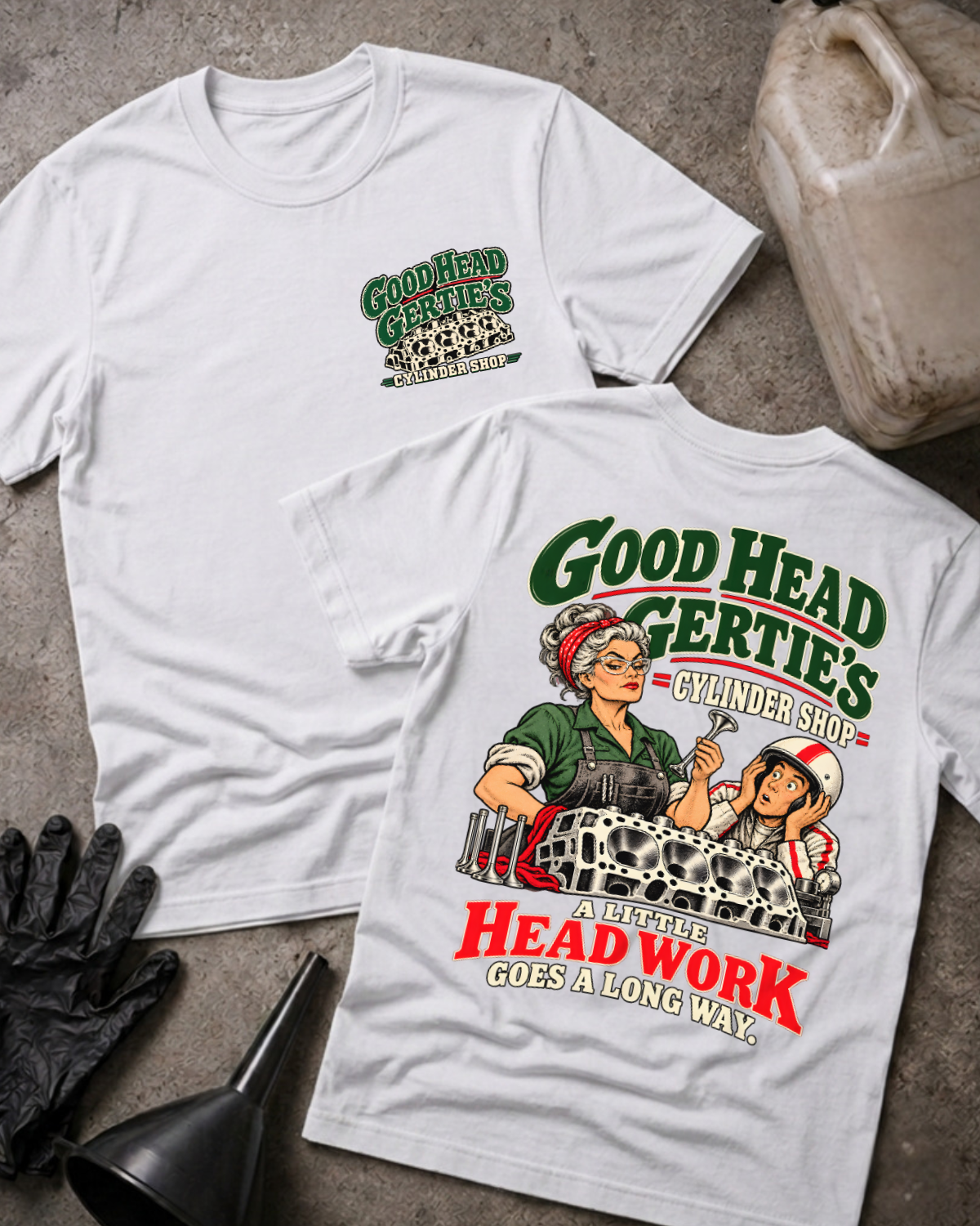 White Good Head Gertie’s Cylinder Shop T-shirt showing the front chest logo and back cartoon of a woman machinist machining a cylinder head beside a racer in a helmet, “A Little Head Work Goes a Long Way,” with gloves, funnel, and oil jug.