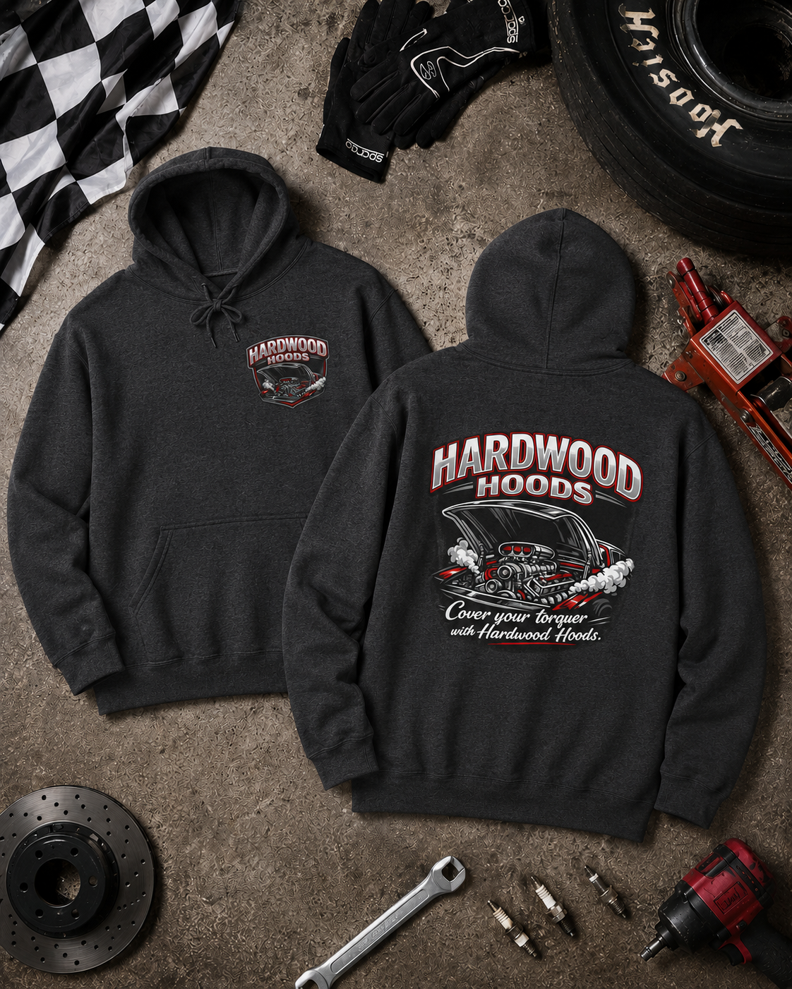 Black hoodie with 'Hardwood Hoods' logo on a textured surface with automotive tools and parts.