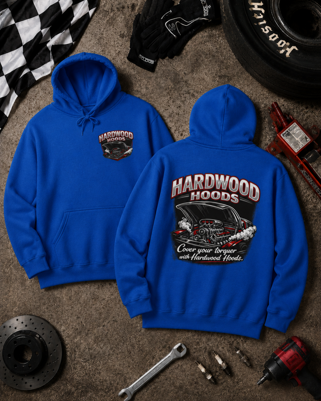 Blue hoodie with 'Hardwood Hoods' logo on a textured surface with tools and a tire.