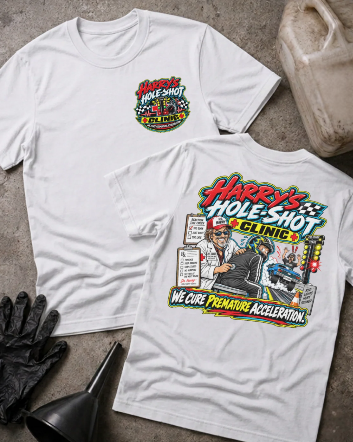 Front and back of Harry’s Hole-Shot Clinic white T-shirt with chest logo, doctor examining a helmeted racer, drag racing lights, and “We cure premature acceleration” slogan.