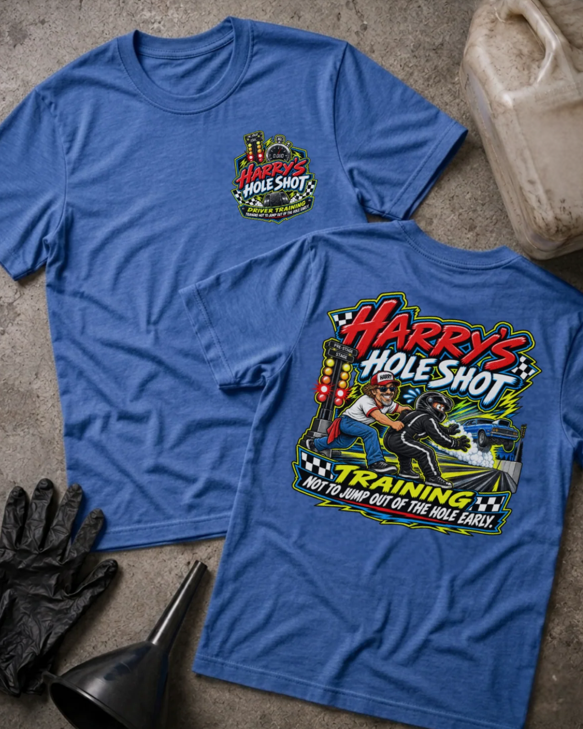 Front and back of Harry’s Hole Shot Training heather true royal T-shirt with chest logo, instructor holding back a helmeted racer beside staging lights, and “Not to jump out of the hole early” slogan.