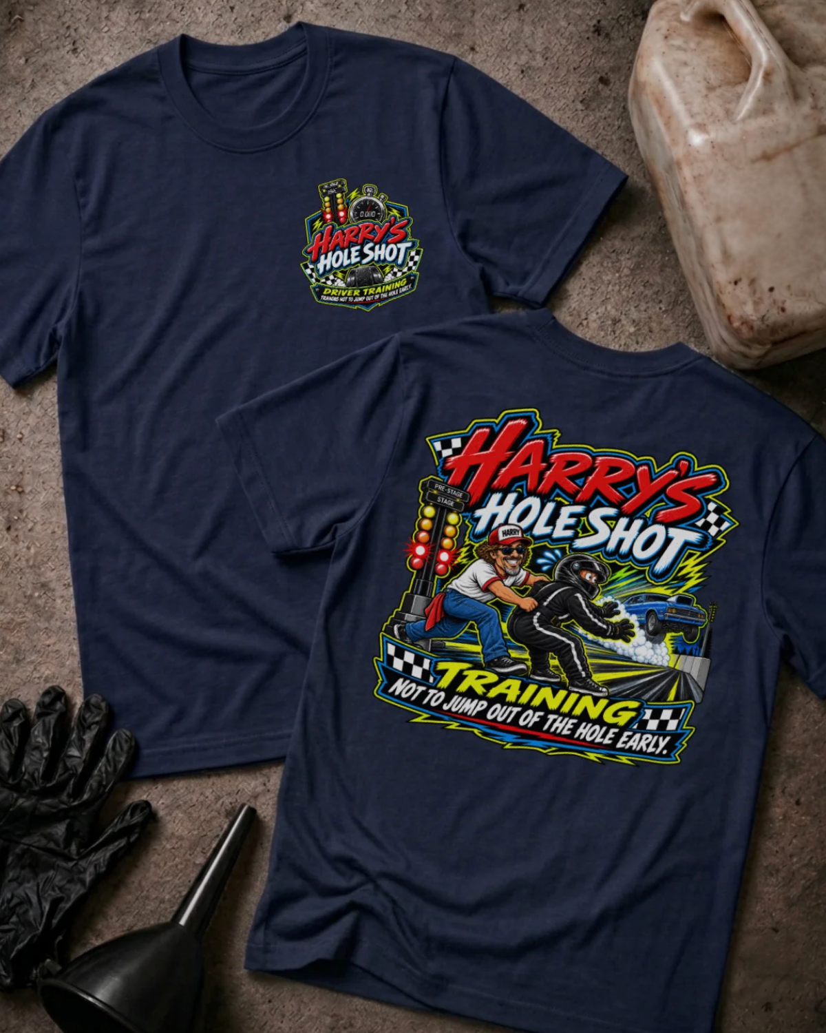 Front and back of Harry’s Hole Shot Training navy T-shirt with chest logo, instructor holding back a helmeted racer beside staging lights, and “Not to jump out of the hole early” slogan.